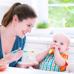 Woman Feeding a Baby